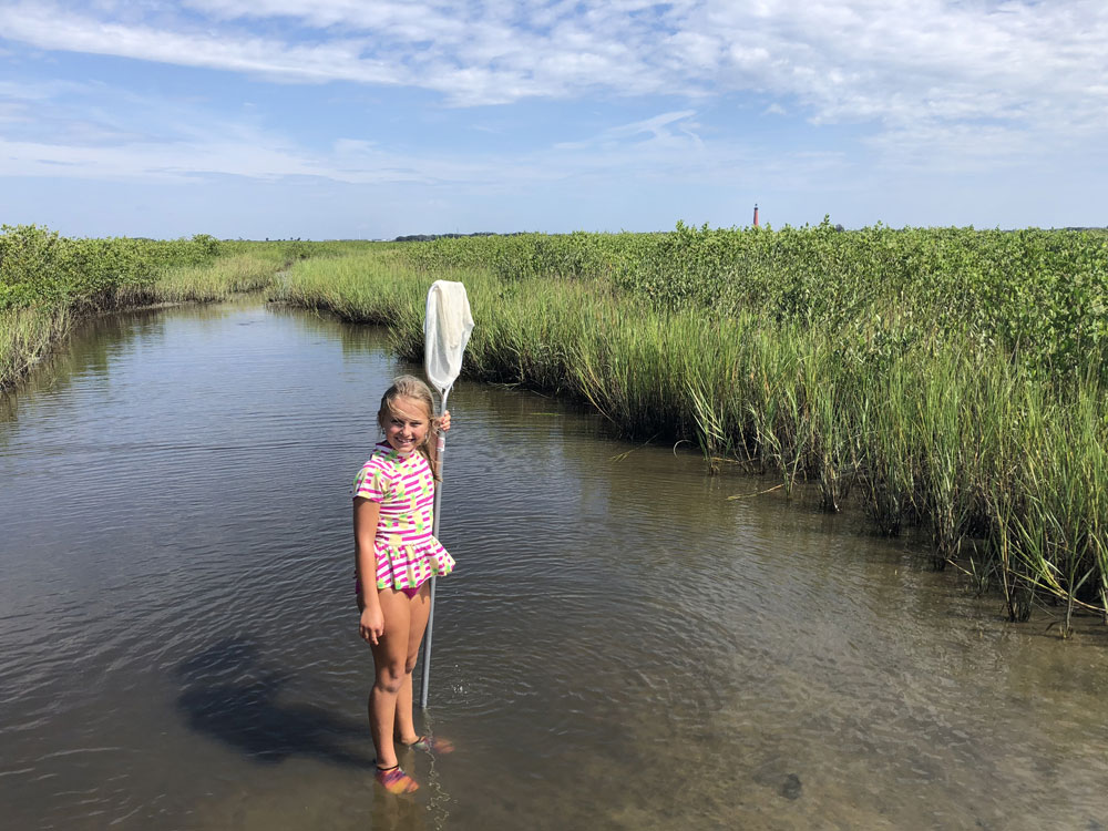 Girl holding a dip net on Marine Discovery Center island exploration