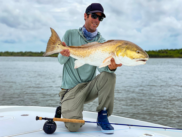 Billy Rotne holds a redfish he caught in the Lagoon