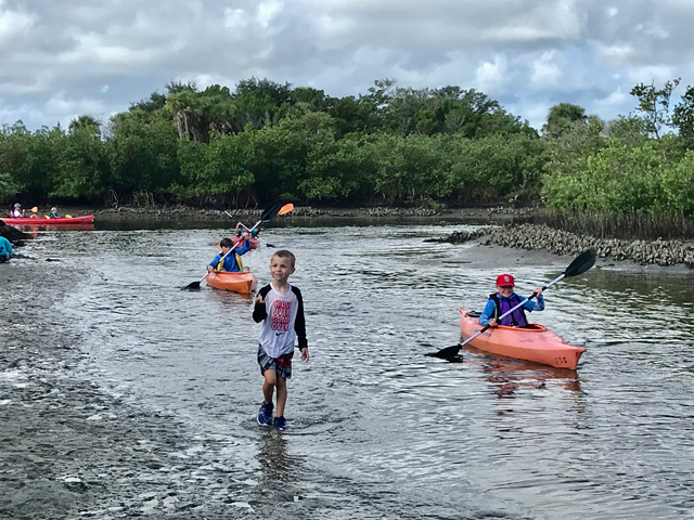 Camp kids kayak, explore, and have fun in the marsh!