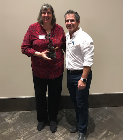 Chad Truxall presents Louise with the Conservation Hero Award in 2018