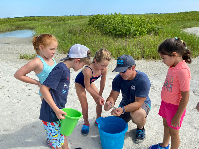 Chad Truxall works with campers at Marine Discovery Center