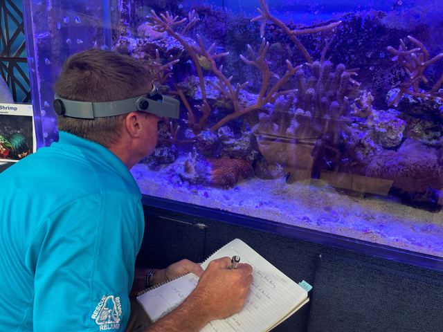 Chad Macfie checks up on the corals at Marine Science Center
